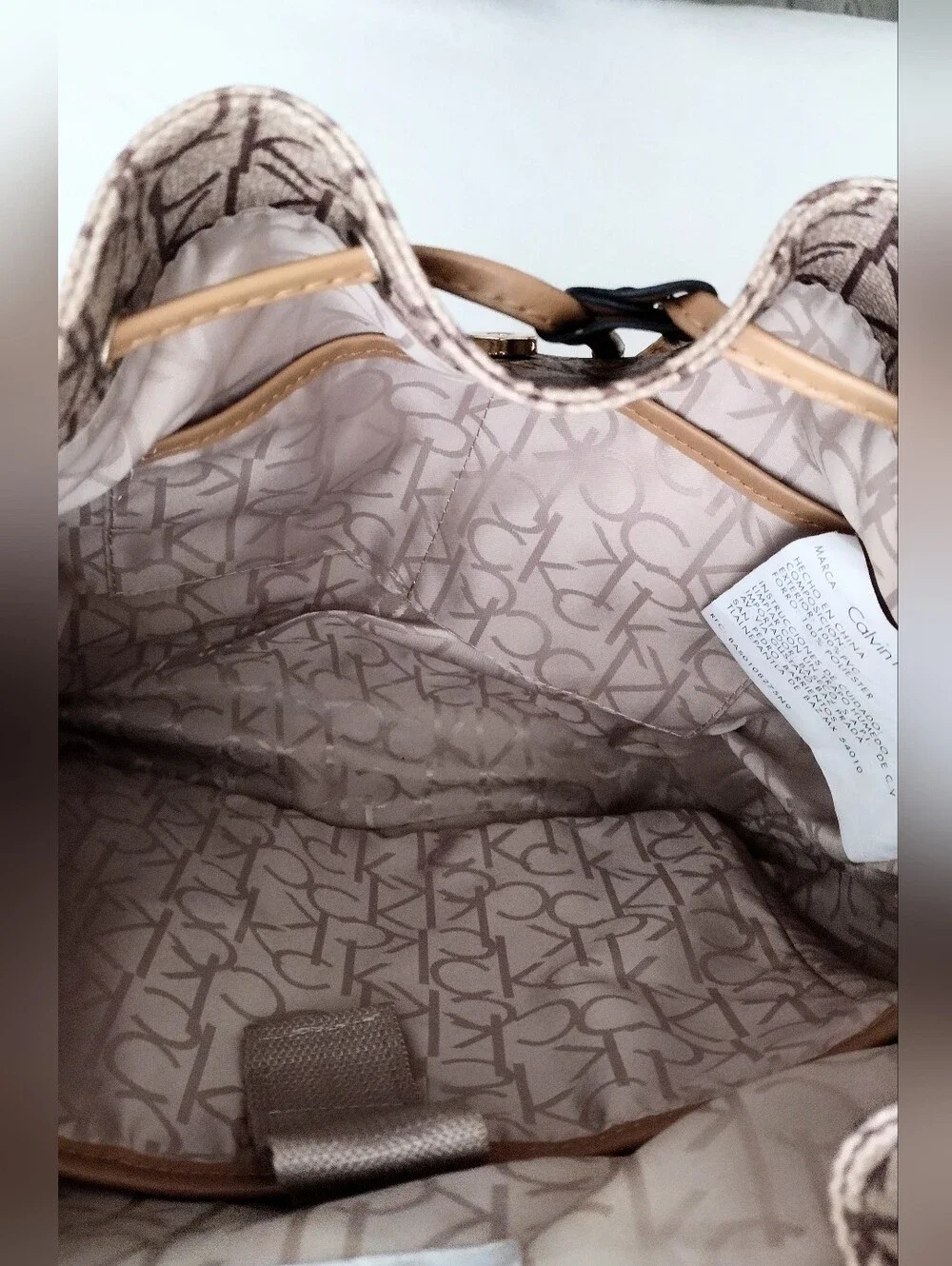 Calvin Klein Monogram Drawstring Backpack in Beige and Brown